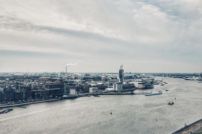 High angle view of buildings by sea against sky