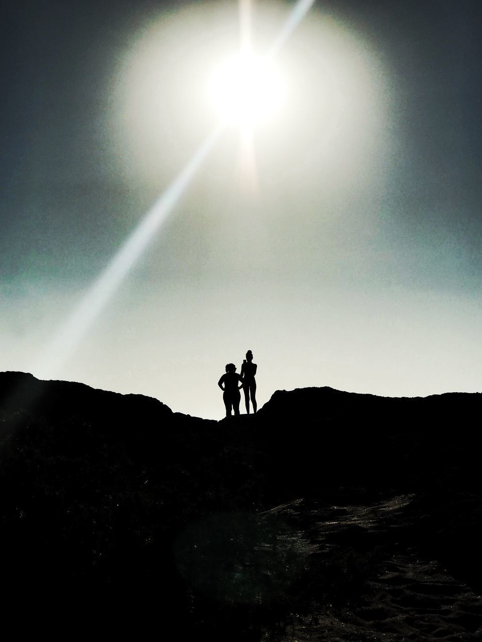 SILHOUETTE MAN STANDING ON MOUNTAIN AGAINST SKY AT SUNSET