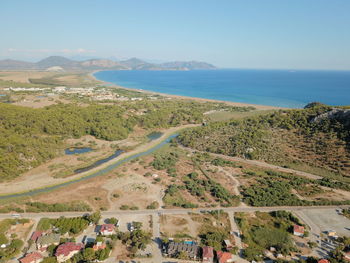 High angle view of land and sea against clear sky