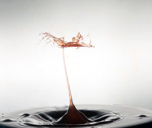 Close-up of liquid splashing against white background