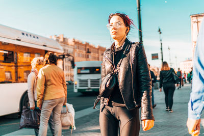 Full length of woman walking on street in city