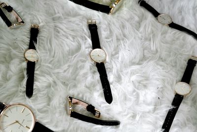 High angle view of wristwatches on fur