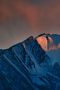 Scenic view of snowcapped mountains against sky during sunset