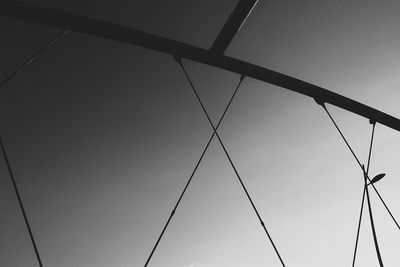 Low angle view of power lines against clear sky