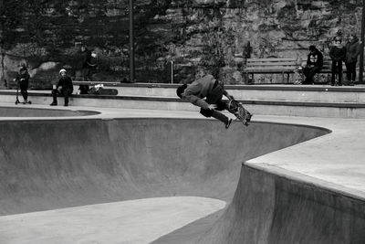 Skater jumps in skate park with the adrenaline flowing on motion