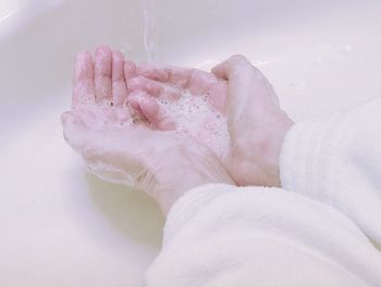 Cropped image of person washing hands