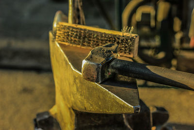 Close-up of hammer and anvil at blacksmith shop