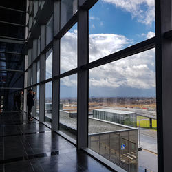 People standing by glass window