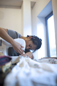 Young woman sewing