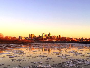 City at waterfront during sunset