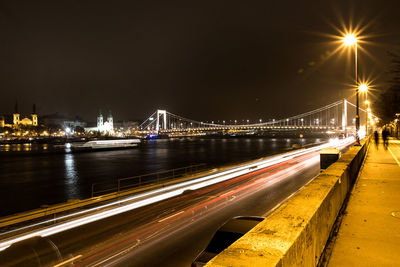 Illuminated elisabeth bridge over danube river in city
