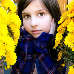 Portrait of woman with yellow flower