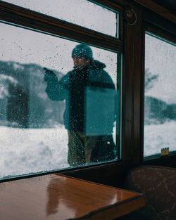 Reflection of man on glass window