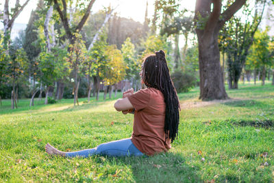 Beautiful young woman is doing yoga outside in a park. concept of healthy lifestyle.