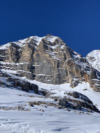 Scenic view of snowcapped mountains against clear blue sky