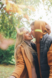 Couple standing outdoors during autumn