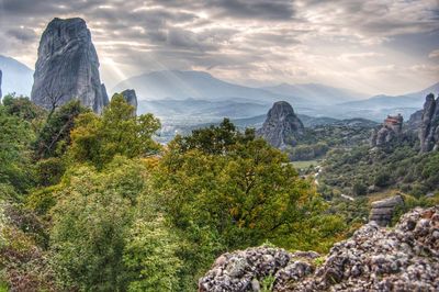 Scenic view of trees and mountains against sky