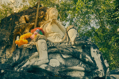 Statue of buddha against trees