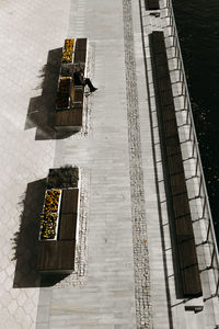 High angle view of arrow sign on street by building