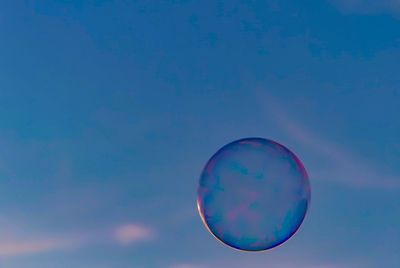 Low angle view of bubbles against sky