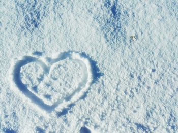 Close-up of heart shape on snow