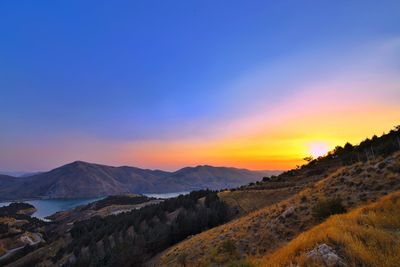 Scenic view of mountains against sky during sunset
