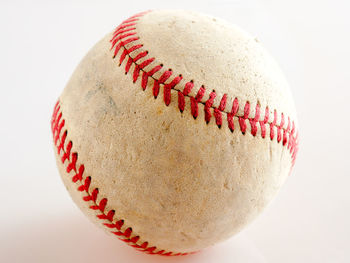 Close-up of baseball over white background