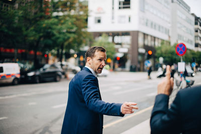 Man looking at city street