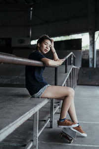 Woman with skateboard on ramp