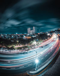 High angle view of illuminated cityscape against sky at night