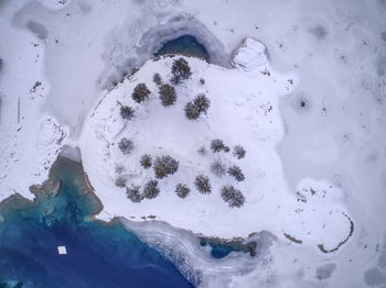 Aerial view of lake and snow covered landscape during winter