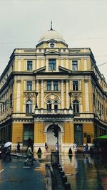 People walking in front of building