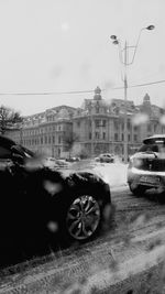 Cars on street against sky