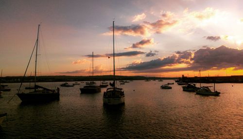 Boats in marina at sunset