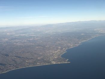 Aerial view of snowcapped mountains against sky