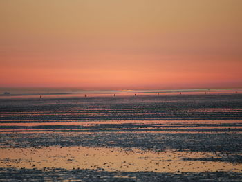 Scenic view of beach against sky during sunset