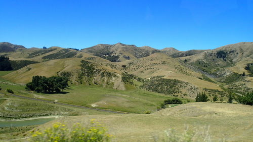 Scenic view of mountains against clear blue sky