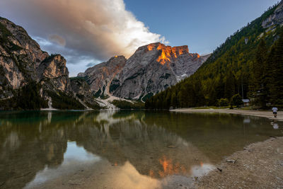 Scenic view of lake by mountains against sky