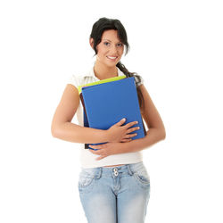 Portrait of a smiling young woman against white background