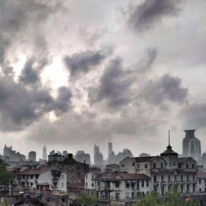 Buildings against cloudy sky