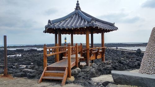 Lifeguard hut on beach against sky