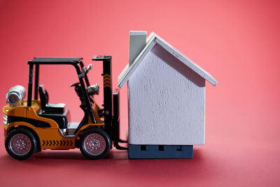 Close-up of toy car against pink background