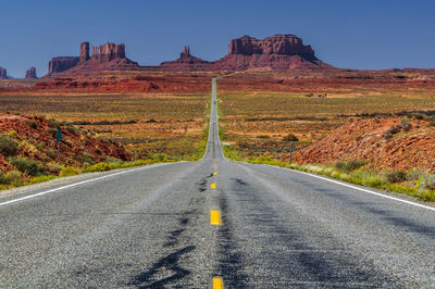 Road amidst land against sky