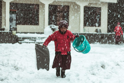 Full length of child standing in snow