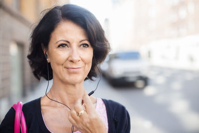 Smiling mature woman with earphones