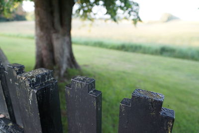 Close-up of wooden fence on field