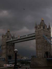 Low angle view of clock tower against cloudy sky