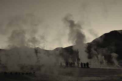 Smoke emitting from volcanic mountain against sky