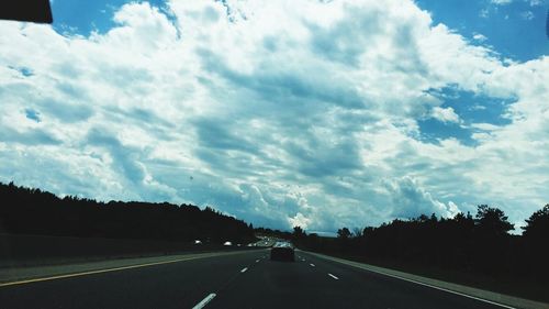 View of road against cloudy sky