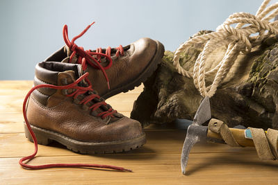 Close-up of shoes with equipment on wooden table